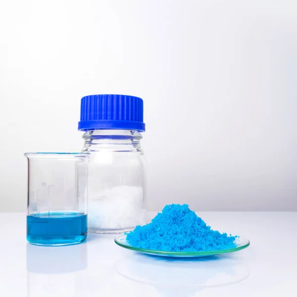 Inorganic chemical on white laboratory table. Copper(II) sulfate, Microcrystalline wax, alcohol. Chemical ingredient for Cosmetics and Toiletries product.