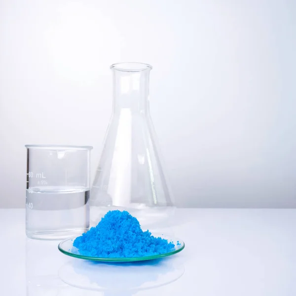 Close up inorganic chemical on white laboratory table. Copper(II) sulfate, alcohol. Chemical ingredient for Cosmetics and  Toiletries product.