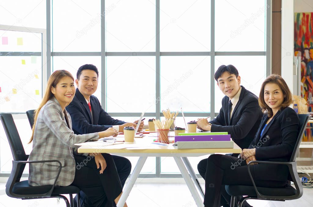 Business executives team meeting in modern office with laptop computer, coffee and document on table. People corporate business team concept.
