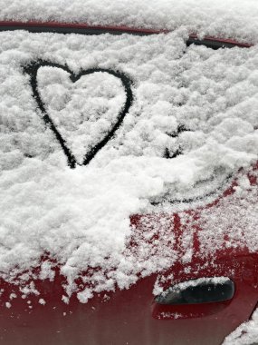 Kar kaplı bir arabanın camına dikey kalp çizilmiş.. 