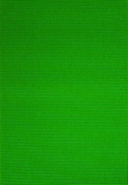 Renkli kağıt ve çizgili dokulardan oluşan parlak bir arka plan. Düz yat, kapat. Yeşil..