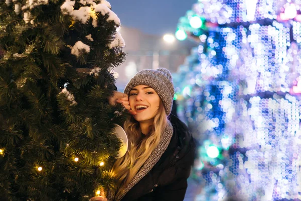 Mooi meisje in wintermuts bij de kerstboom, wintervakantie, vakantie en wandelingen foto onder een film foto met graan — Stockfoto