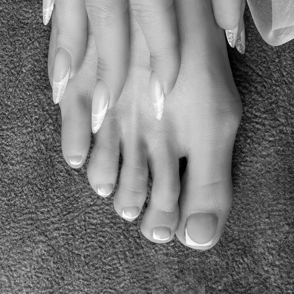 Leg, barefoot with pedicure and hand with manicure