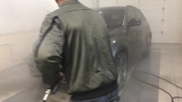 2021年3月3日 俄罗斯 莫斯科 一名男子在洗车场用喷射水洗了一辆汽车 用强大的喷射水洗去了汽车上的污垢 — 图库视频影像