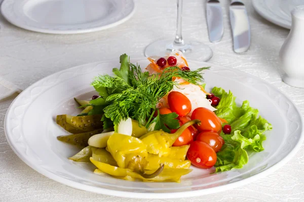 Pickled cucumbers, tomatoes, sauerkraut with cranberries and marinated chilli peppers — Stock Photo, Image