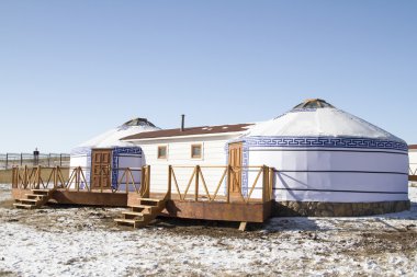 Yurts in the tourist camp in Mongolia in winter clipart
