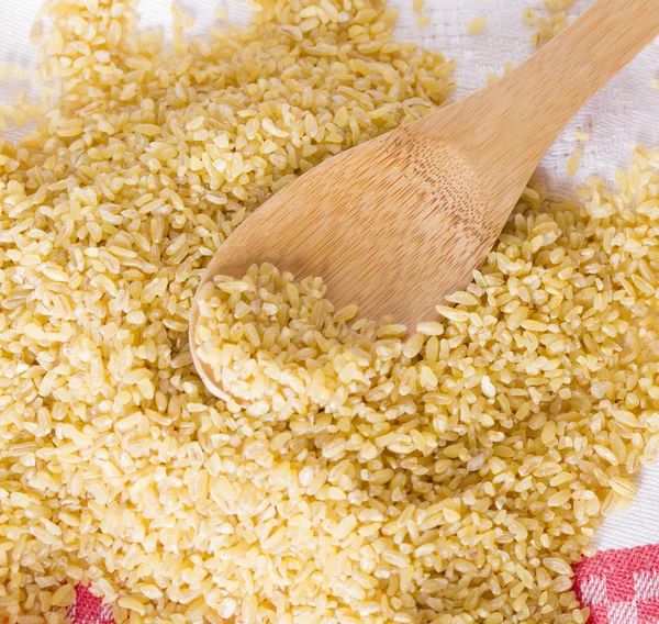 Bulgur in a wooden spoon — Stock Photo, Image