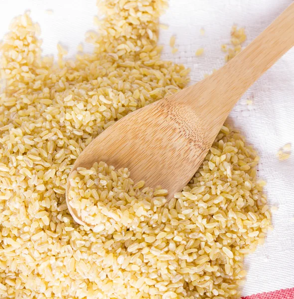 Bulgur in a wooden spoon — Stock Photo, Image