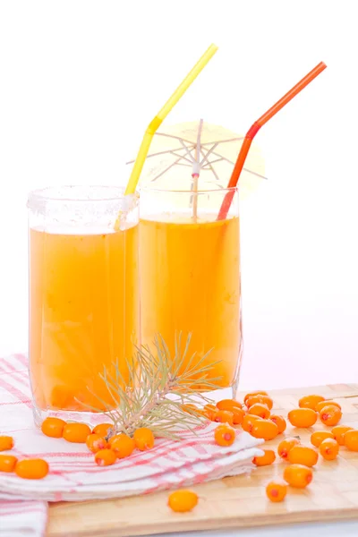 Two glasses with sea buckthorn fruit drink and sea-buckthorn ber