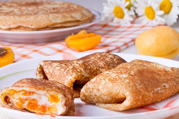 Pancakes with curd cheese and dried apricots — Stock Photo, Image