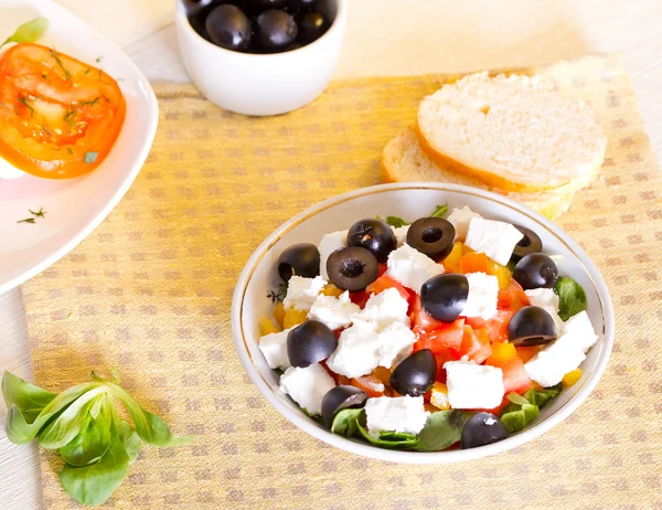 Greek salad, bread and olives on the table — Stock Photo, Image