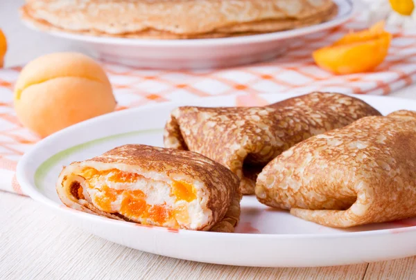 Pancakes with curd cheese and dried apricots — Stock Photo, Image