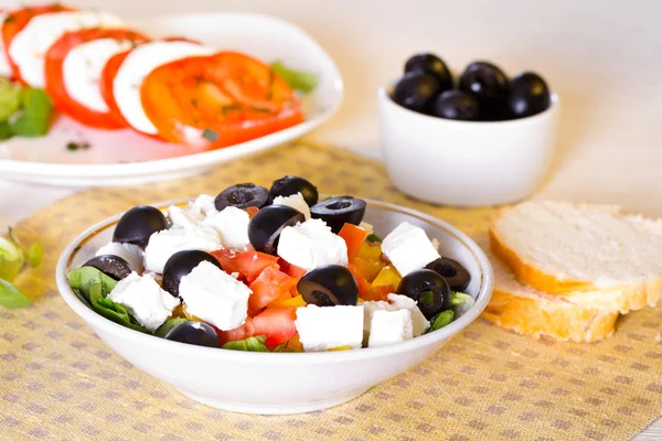 Greek salad, bread and olives on the table — Stock Photo, Image