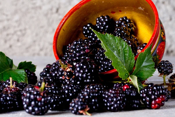 Blackberries on the old wooden table in traditional Russian dish — Stock Photo, Image