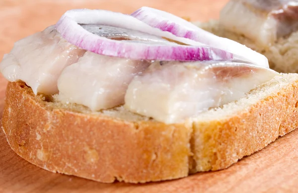Sandwich with herring and onions — Stock Photo, Image