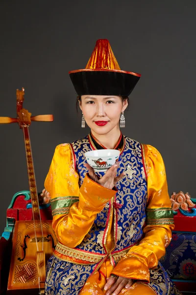 Carino ragazza asiatica in costume Buryat bere il tè Foto Stock