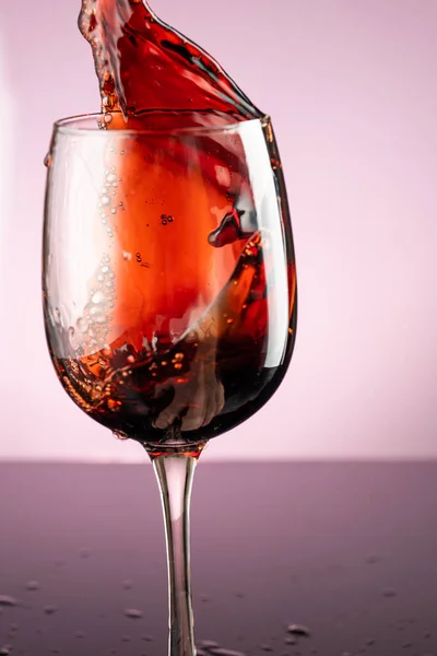 Stänk Rött Vin Glas Röd Bakgrund — Stockfoto