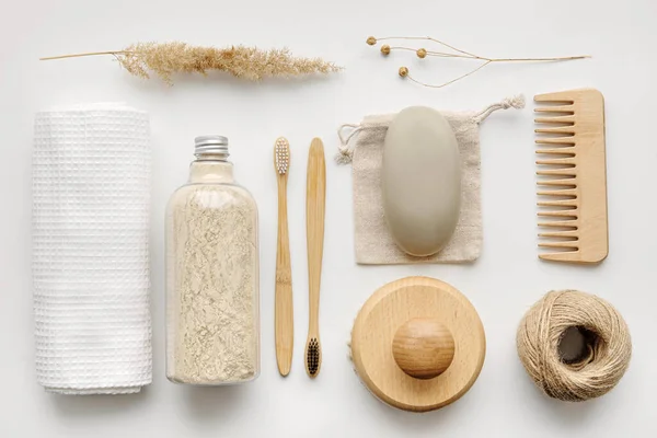 Towel, body scrub, soap, wooden comb, beech toothbrushes, sea bath salt, body brush and other spa objects on light background.Top view, Flat lay. Skin care, body treatment concept.Knolling composition.