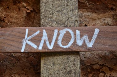 word know on a wooden block on the old wooden background
