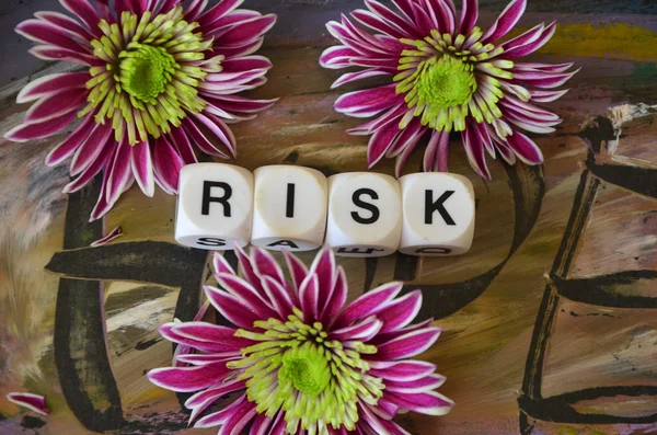 Word risk and flowwers — Stock Photo, Image