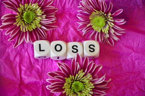 Slovo ztráty a květiny — Stock fotografie