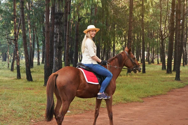 Young Woman Shirt Straw Hat Rides Brown Horse Park Blurred — Stock Photo, Image