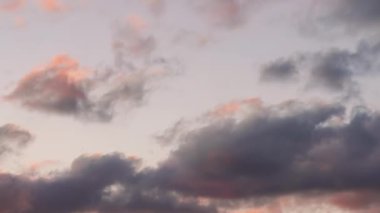 Kırmızı, mor, turuncu ve mavi bulutlar gün batımında rüzgarda hareket ediyor - zaman kavramı videosu