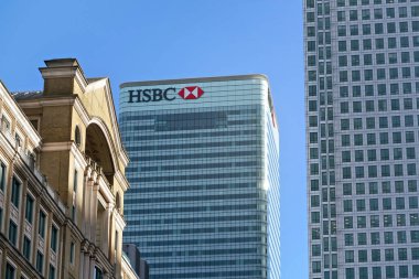London, United Kingdom - February 03, 2019: Sun shines on world Headquarters of HSBC Holdings plc at 8 Canada Square, Canary Wharf. It is 7th largest bank worldwide, was established in 1865 clipart