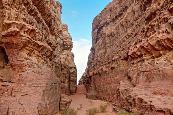 Rocky canyon with red sand on ground - Wadi Rum scenery