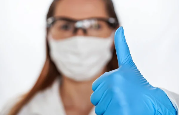 Hand Blue Protective Glove Showing Thumb Blurred Woman Face Cotton — Stock Photo, Image