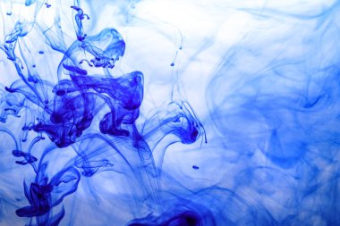 Şırıngadan suya mavi mürekkep enjekte edilmiş. Suyla karıştırılmış. Soyut şekiller yaratıyor.