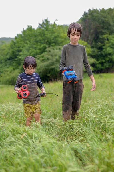 雨の日に二人の兄弟が家に帰ってきておもちゃを持って — ストック写真