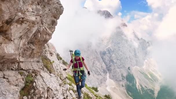 美しい若い登山家の女性は 晴れた夏の日に山の中でFerrataを歩く — ストック動画
