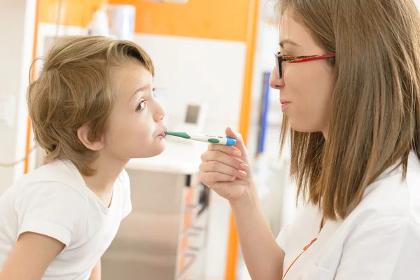 Cute boy being checked at clinic — Stock Photo, Image