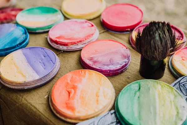 multi-colored paints for body art on a small table 2