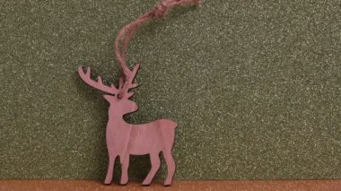 Wooden Christmas decoration, deer on Golden defocused glitter background