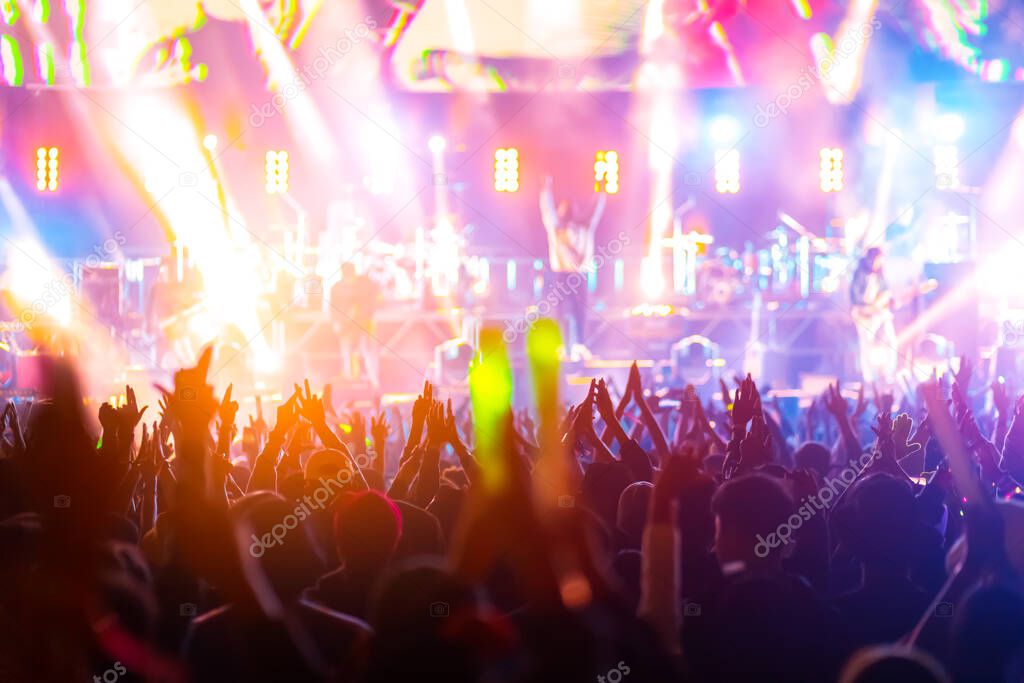 crowd with raised hands at concert festival