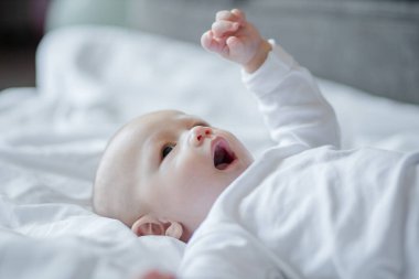 Beyaz yatakta şirin bir bebek. Bebeğim, yeni doğan kavramı.