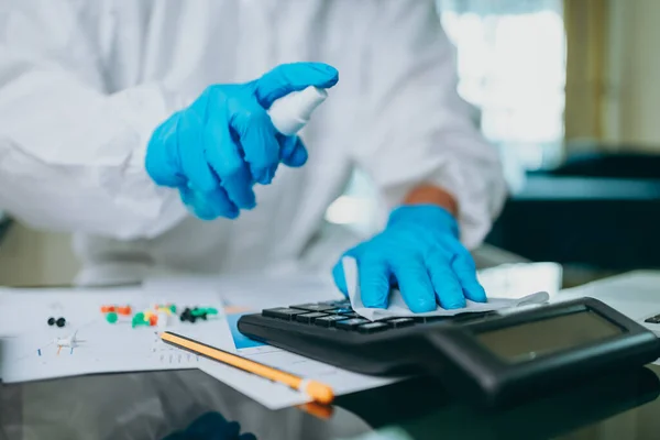 Scientists are cleaning calculate by alcohol and tissue after checking and testing virus on labtop at home.