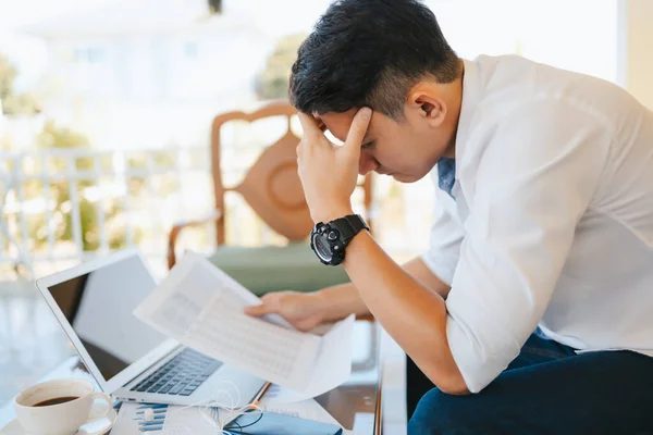 Tired businessman at workplace in office holding his headache or angry. Overworking, making mistake, stress, termination, fail, bad, sad tired or depression concept