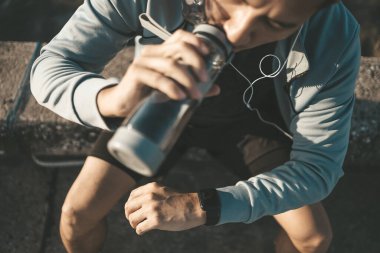 Spor adamı antrenman sırasında ve parkta koşarken Akıllı Saati kontrol ediyor.. 