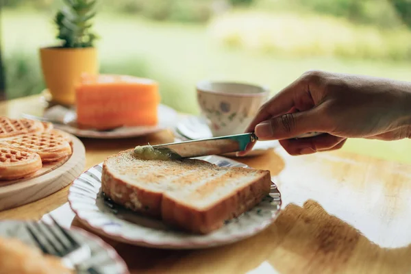 Nóż Rozkładający Masło Chleb Tostowy Dłoniach Podczas Porannego Śniadania Koncepcja — Zdjęcie stockowe