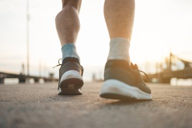 Gün batımında yolda koşan adam..