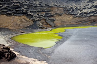 Siyah kaba yanardağ krater içinde yeşil lagoon