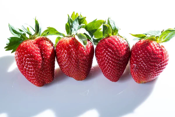 Detail Photo Four Very Red Strawberries Green Leaves White Background Imagens Royalty-Free