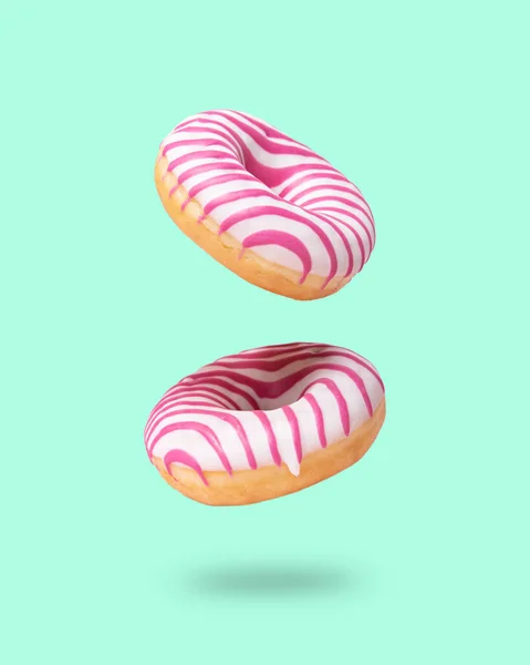 Dos Rosado Esmaltado Donut Volando Sobre Neo Menta Fondo Concepto — Foto de Stock