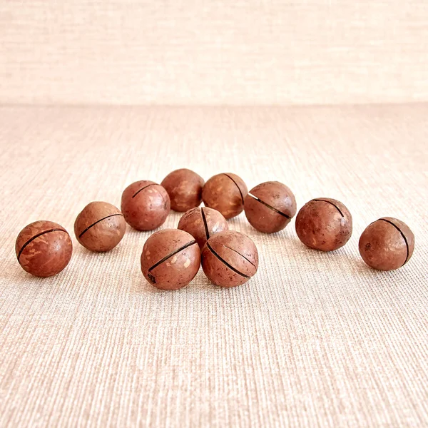 Καρύδια Macadamia Απλώνονται Σχήμα Βέλους Φτέρωμα Μια Ανοιχτόχρωμη Μπεζ Οριζόντια — Φωτογραφία Αρχείου