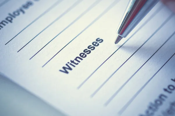 Hand writing on incedent witnesses paper. Stock Photo