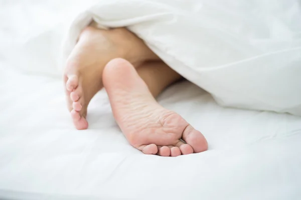 Feet in bed — Stock Photo, Image