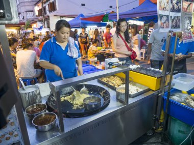 Street food vendor making stir fried food at Jonker street in Ma clipart